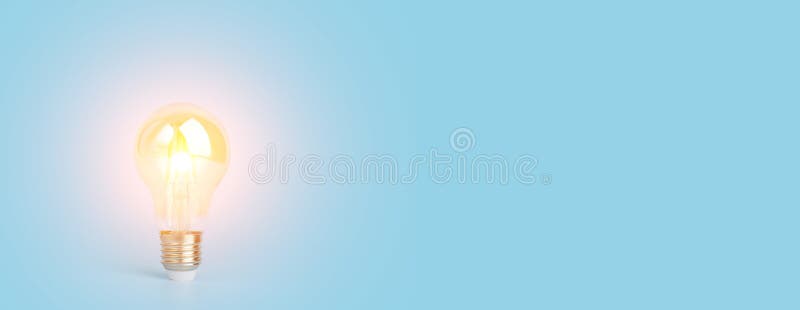 Knowledge and idea concept. Light bulb with light on a blank blue banner background. Brain, wisdom, knowledge and energy stock photography