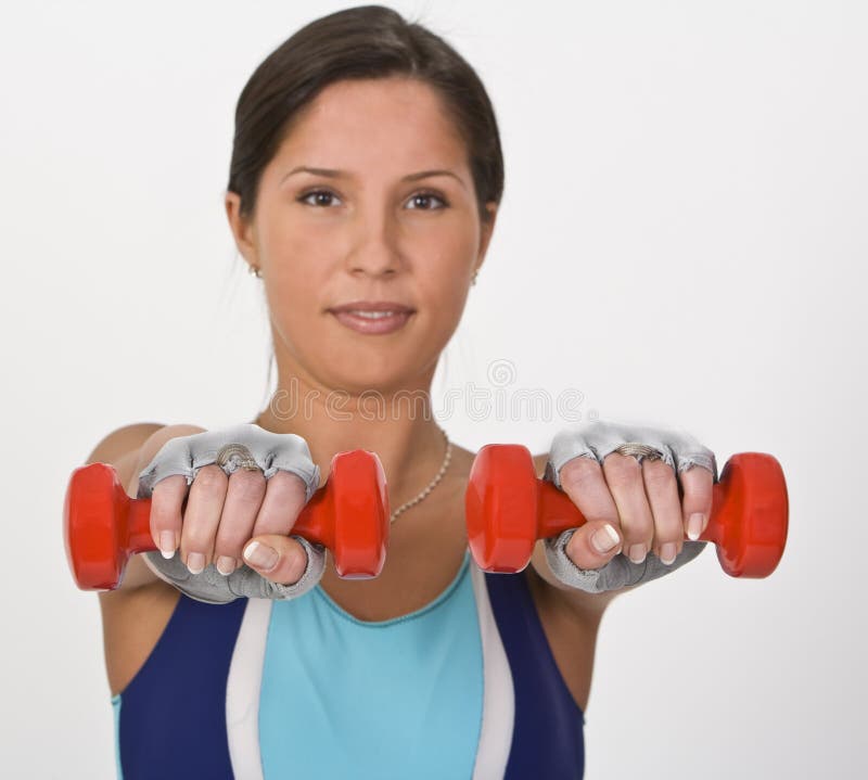 Image of a young woman doing barbells exercises,selective focus on the barbells. Take a look to my entire. Image of a young woman doing barbells exercises,selective focus on the barbells. Take a look to my entire