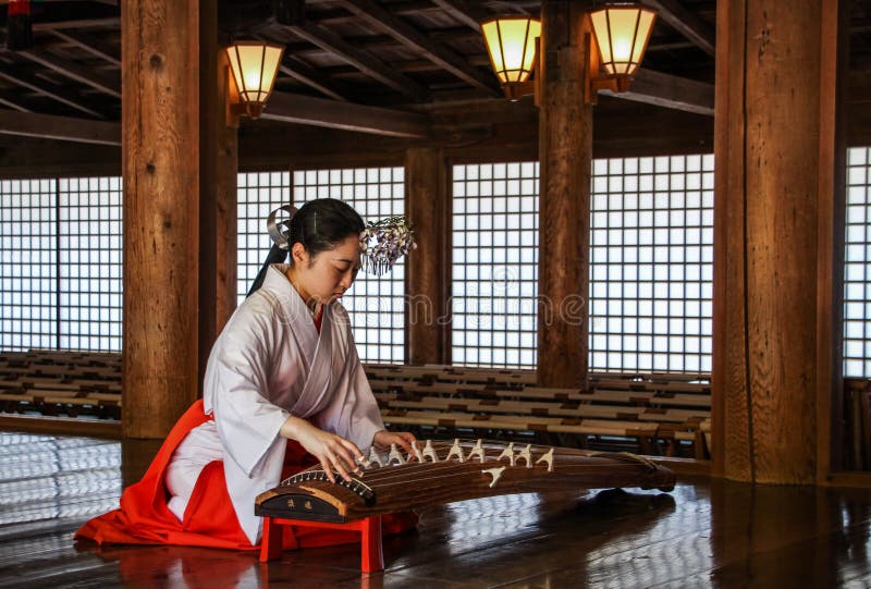 Kobieta bawić się Koto w Kasuga-taisha świątyni, Nara prefektura, Kansai, Japonia