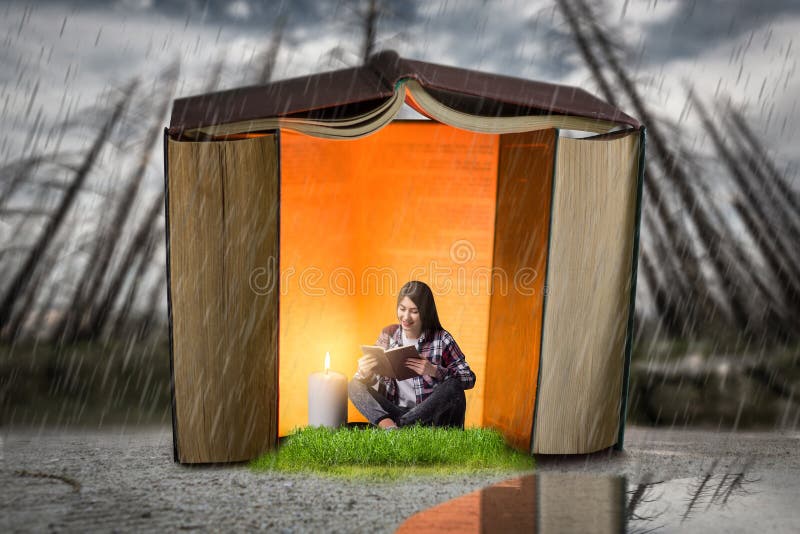 Woman reads in a house built of books, scale effect. Reading concept, small man in a big world of knowledge. Woman reads in a house built of books, scale effect. Reading concept, small man in a big world of knowledge