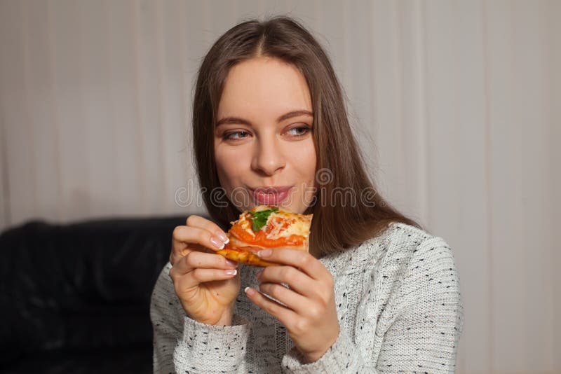 Young woman is eating delicious pizza. Young woman is eating delicious pizza