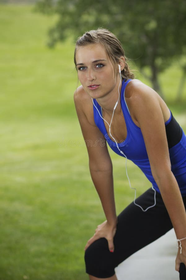 Beautiful woman after a hard workout catching her breath. Lots of copy space to the left. Beautiful woman after a hard workout catching her breath. Lots of copy space to the left