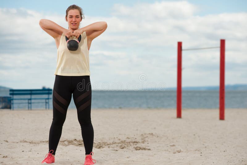 Kobieta podnosząca ciężar kettlebella na sali fitness na zewnątrz. zdjęcie royalty free