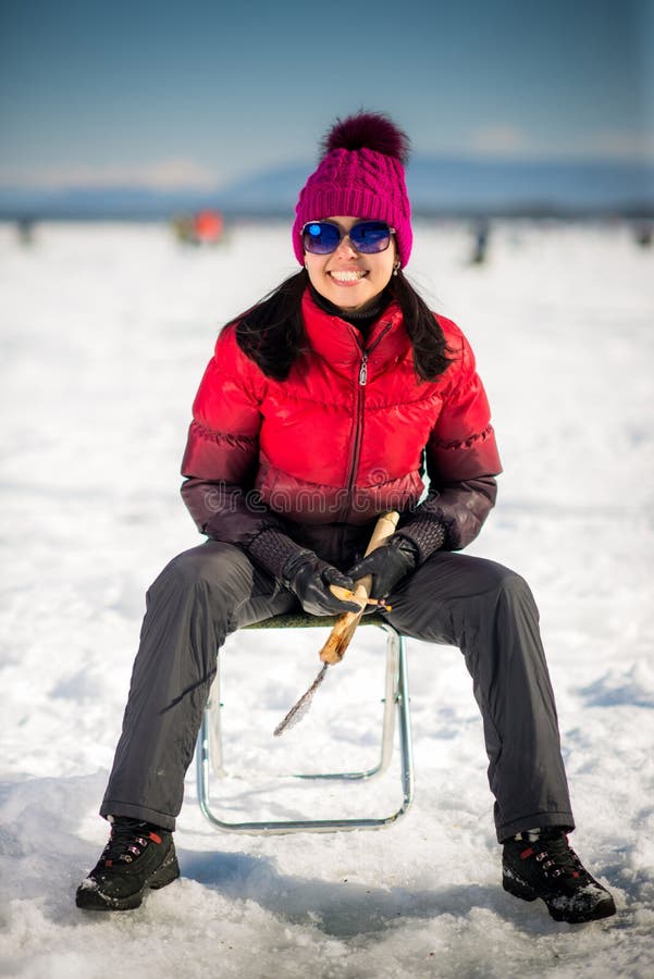 Woman ice-fishing in the winter on the lake. Woman ice-fishing in the winter on the lake