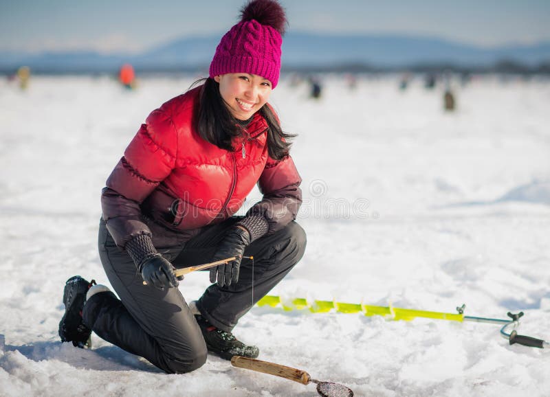 Woman ice-fishing in the winter on the lake. Woman ice-fishing in the winter on the lake