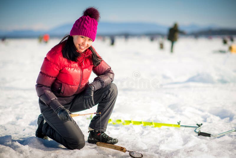 Woman ice-fishing in the winter on the lake. Woman ice-fishing in the winter on the lake