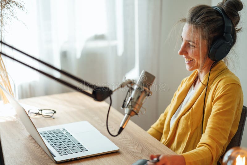 Kobieta pracująca w domu i rozmawiająca na mikrofonie i nagrywająca podcast obraz stock