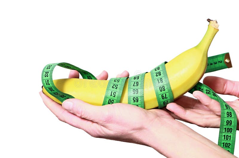 Kobieta trzyma zdrowego banana i taśmy miary obraz stock Kobieta trzyma zdrowego banana i taśmy miary obraz stock