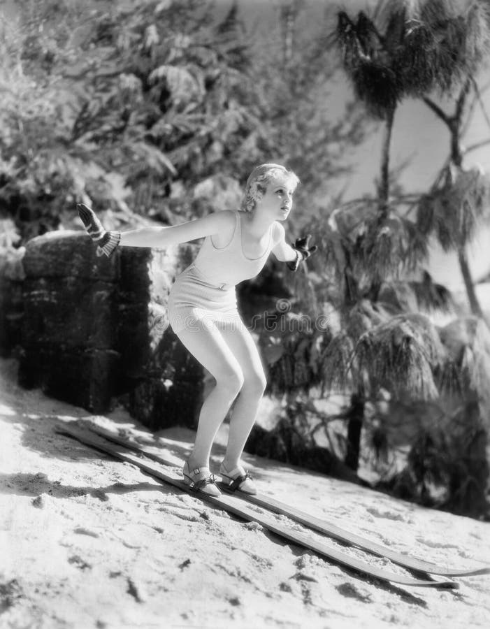 Woman In a bathing suit skiing down a hill (All persons depicted are no longer living and no estate exists. Supplier grants that there will be no model release issues.). Woman In a bathing suit skiing down a hill (All persons depicted are no longer living and no estate exists. Supplier grants that there will be no model release issues.)