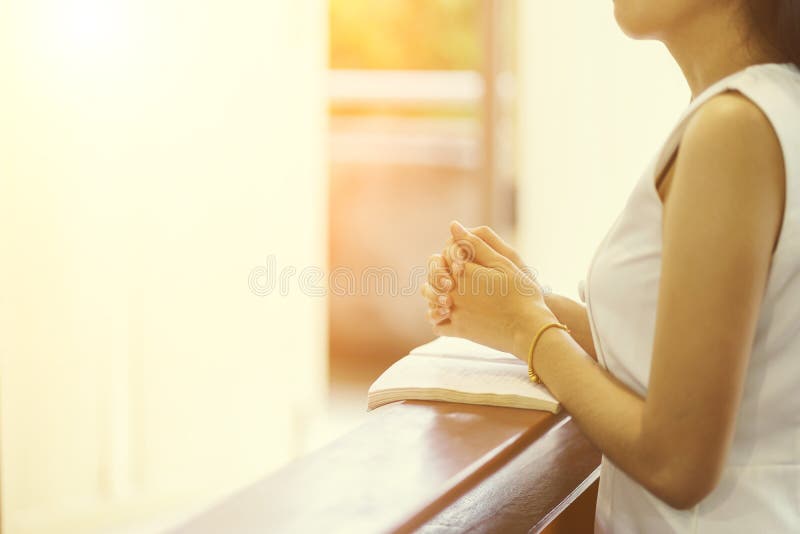 Woman hands praying on a holy bible in church for faith concept, Spirituality and Christian religion. Woman hands praying on a holy bible in church for faith concept, Spirituality and Christian religion.