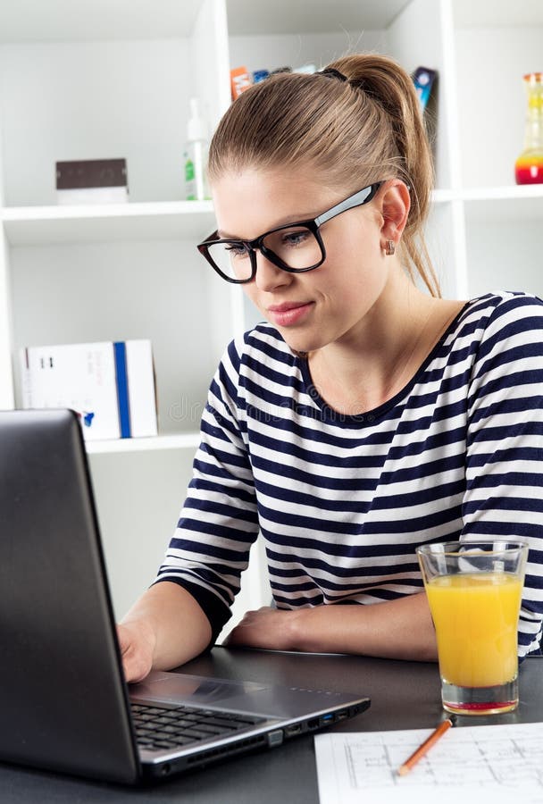 Young woman blogging looking at computer at home. Social network and media concept. Young woman blogging looking at computer at home. Social network and media concept.