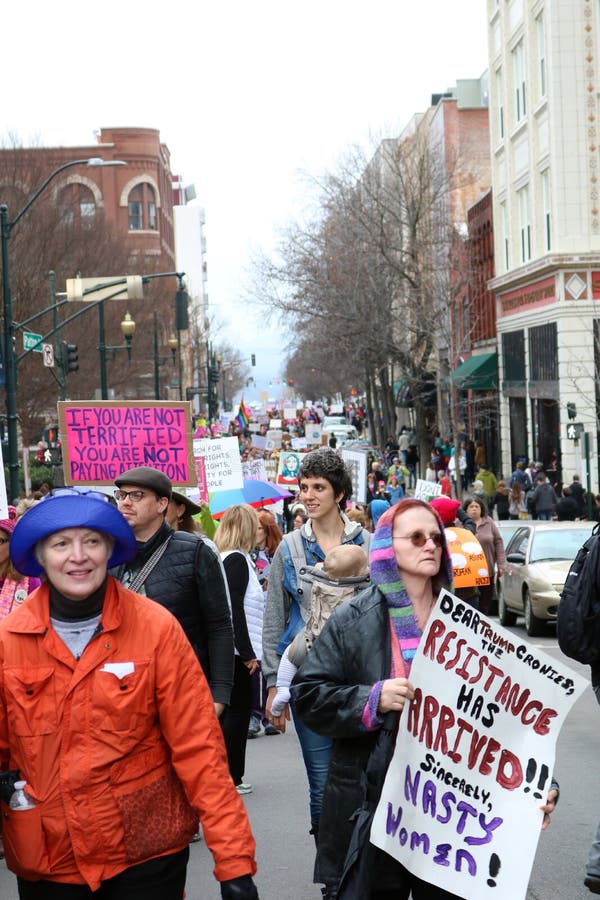 Verical view of downtown street filled with people marching Womens` March on Asheville NC January 21st 2017. Verical view of downtown street filled with people marching Womens` March on Asheville NC January 21st 2017