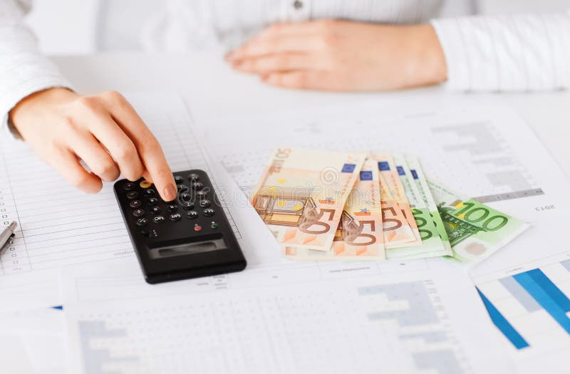 Business, office, household, school, tax and education concept - woman hand with calculator and euro money. Business, office, household, school, tax and education concept - woman hand with calculator and euro money