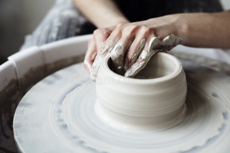 Kobiety ` s ręk zamknięty up władczy studio ceramics pracuje z gliną na garncarki ` s kole