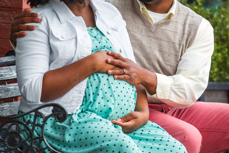 Loving African American couple expecting their first child. Loving African American couple expecting their first child.