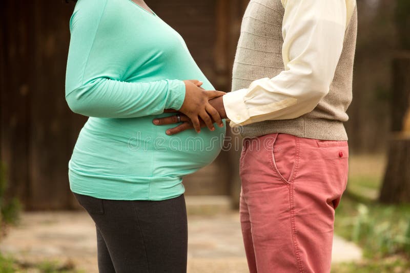 Loving African American couple expecting their first child. Loving African American couple expecting their first child.