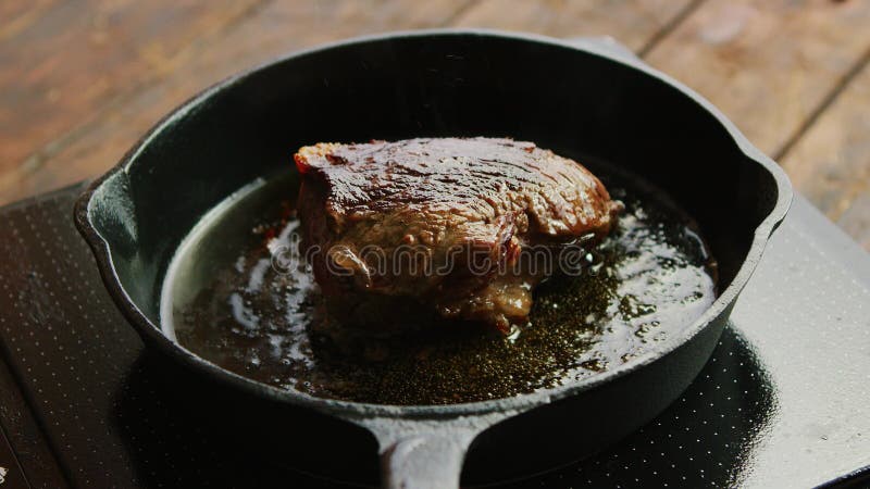 Koekepan met gebraden vlees op fornuis