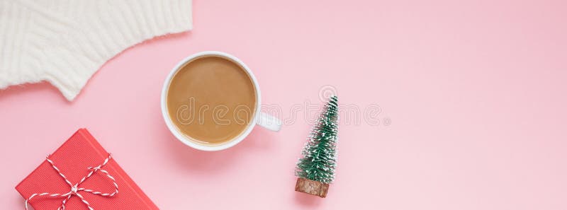 Creative christmas flat lay overhead top view coffee milk latte cup and present gift box on millennial pink background copy space minimal style. Christmas mood template feminine blog Long wide banner. Creative christmas flat lay overhead top view coffee milk latte cup and present gift box on millennial pink background copy space minimal style. Christmas mood template feminine blog Long wide banner