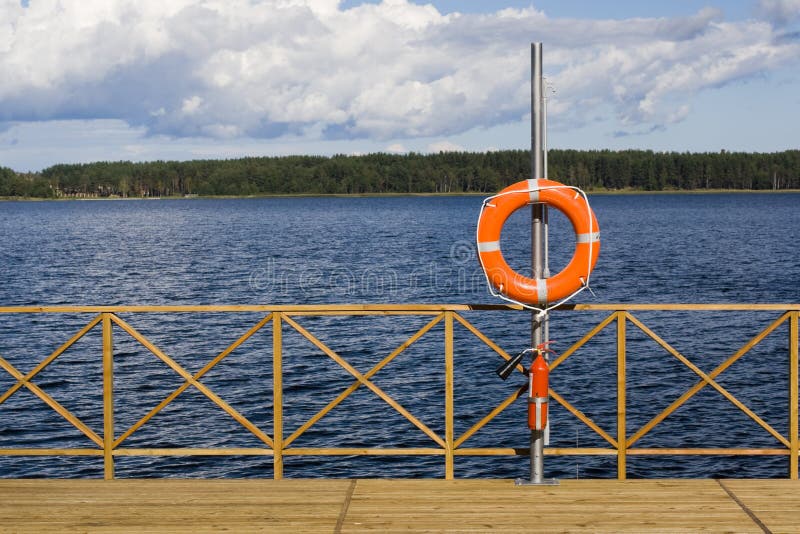 Ring buoy on the berth. Sukhodolskoe lake, Russia. Ring buoy on the berth. Sukhodolskoe lake, Russia