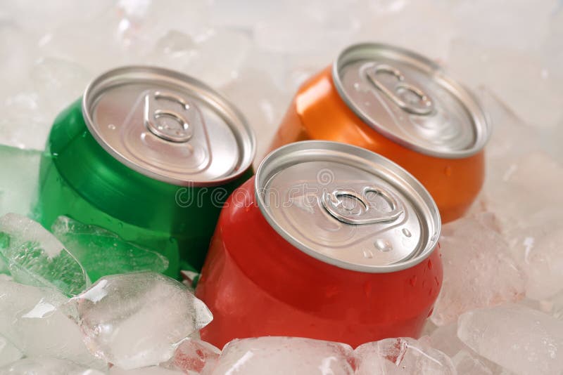 Cold cola and cool lemonade in cans on ice cubes. Cold cola and cool lemonade in cans on ice cubes