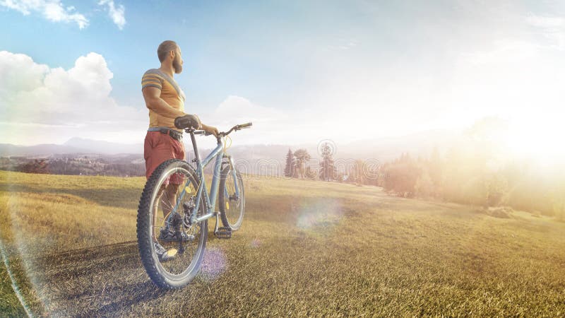 Kolarstwo Mężczyzna z rowerami na leśnej drodze w górach w letni dzień Dolina górska podczas wschód słońca Sport