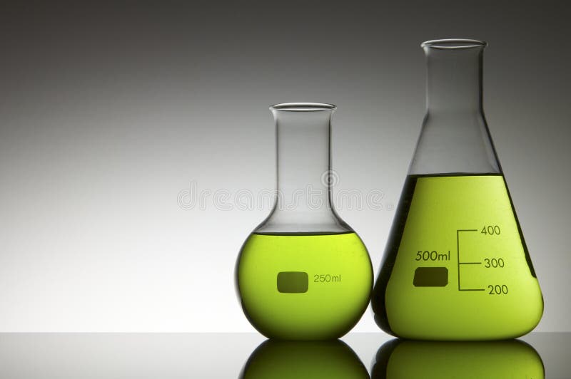 Two flasks with liquid bright green and white background. Two flasks with liquid bright green and white background