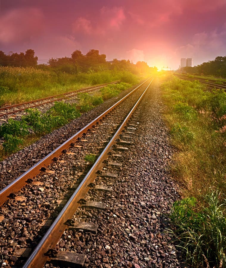 The railway tracks in sun raise moment with flare of sun. The railway tracks in sun raise moment with flare of sun