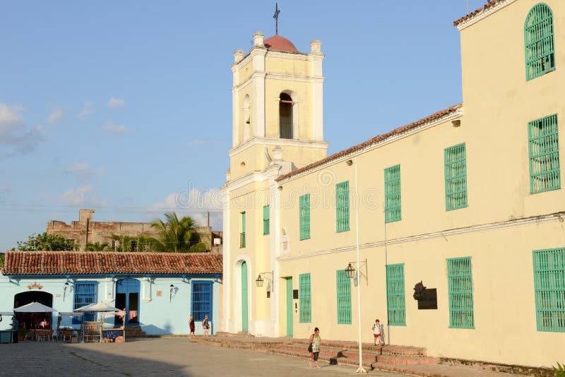 Camaguey, Cuba - 11 January 2016: People walking on colonial San Juan de Dios square at Camaguey on Cuba. Camaguey, Cuba - 11 January 2016: People walking on colonial San Juan de Dios square at Camaguey on Cuba