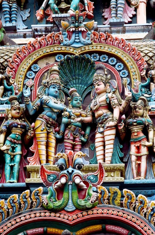 Colored statue on the wall in front of the entrance to the hindu temple with ornament and decorations. Man and woman figure, statues of hindu gods such as Ganesh, Vishnu, Shiva and Krishna, Minakshi godess and mytholigical creatures with many hands or eyes. Colored statue on the wall in front of the entrance to the hindu temple with ornament and decorations. Man and woman figure, statues of hindu gods such as Ganesh, Vishnu, Shiva and Krishna, Minakshi godess and mytholigical creatures with many hands or eyes.