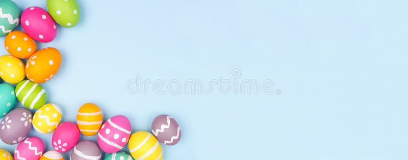 Colorful Easter Egg corner border over a pastel blue paper banner background. Copy space. Colorful Easter Egg corner border over a pastel blue paper banner background. Copy space