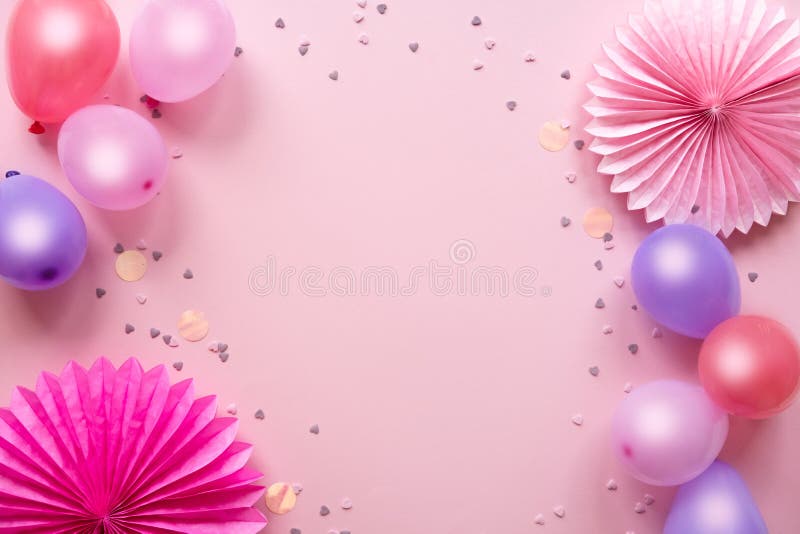 Colorful balloons and confetti on pink table top view. Birthday, holiday or party background. Flat lay style. Empty space for text. Festive greeting card. Colorful balloons and confetti on pink table top view. Birthday, holiday or party background. Flat lay style. Empty space for text. Festive greeting card