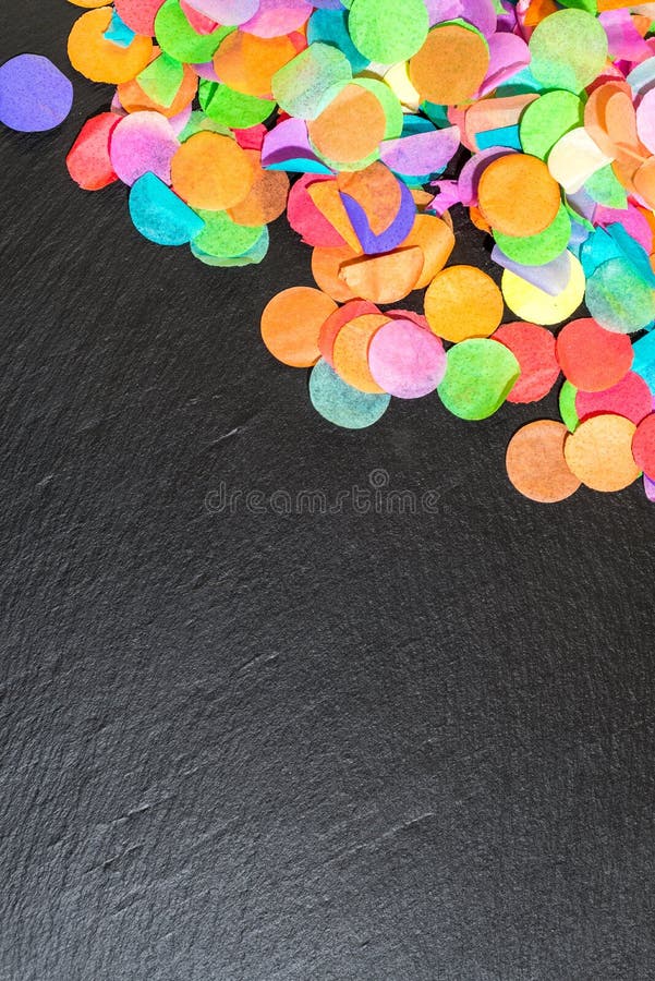 Kolorowi confetti na czarnym iłołupku jako szablon dla świętowania zdjęcie stock Kolorowi confetti na czarnym iłołupku jako szablon dla świętowania zdjęcie stock