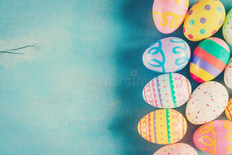 Colorful easter egg on blue pastel color wood background with space. Colorful easter egg on blue pastel color wood background with space.