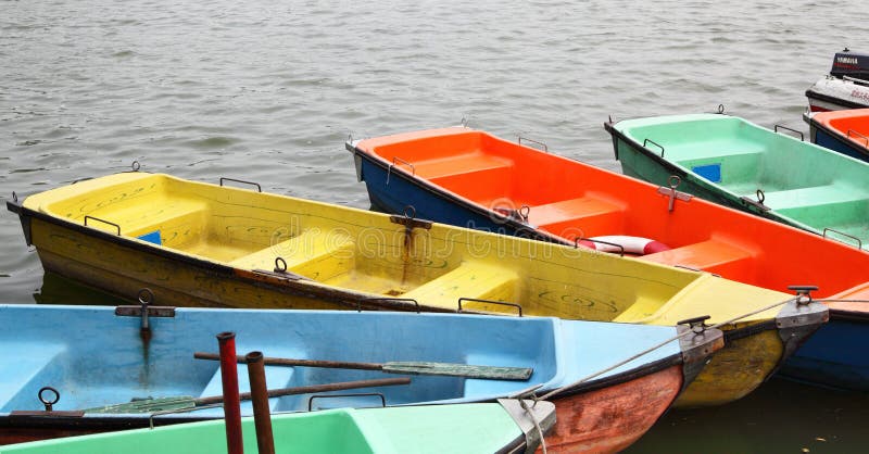 Colorful recreation boats in a row at lake. Colorful recreation boats in a row at lake