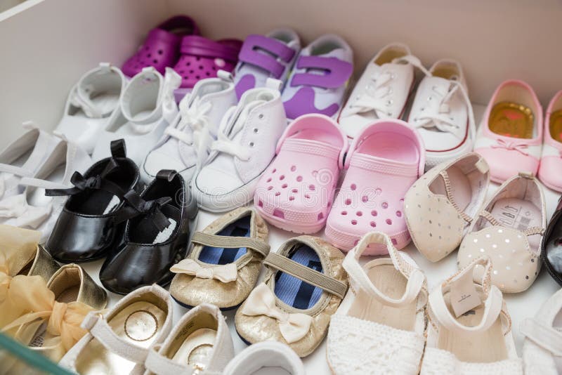 Colorful brand new baby girl shoes inside closet with bright lighting. Colorful brand new baby girl shoes inside closet with bright lighting