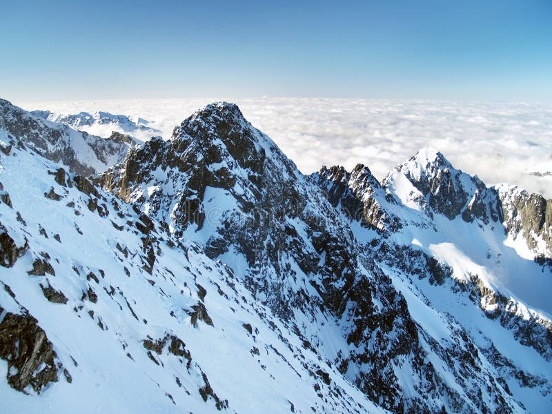 Kolovy peak (Kolovy stit) in High Tatras during winter. Alpine view of mountain peaks in Slovak High Tatras during winter. Dominant peak on this photo is Kolovy stock photo Kolovy peak (Kolovy stit) in High Tatras during winter. Alpine view of mountain peaks in Slovak High Tatras during winter. Dominant peak on this photo is Kolovy stock photo