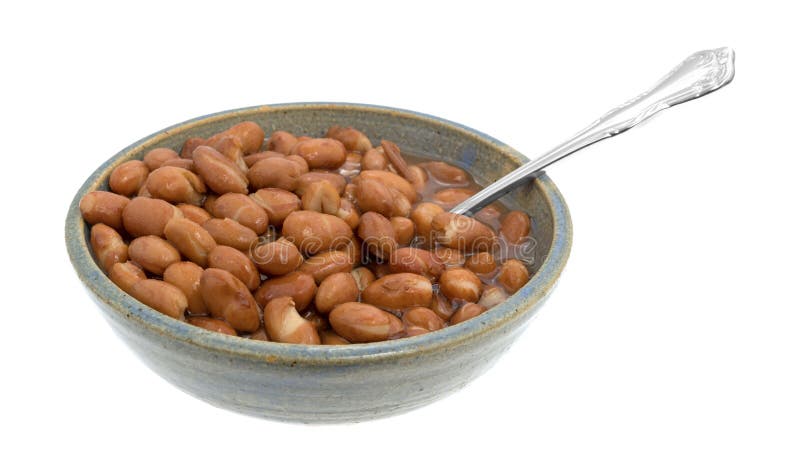 Kom van geschilde bonen met een lepel stock afbeeldingen