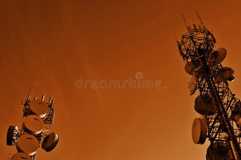 Two communications towers. In sepia tone. Two communications towers. In sepia tone.