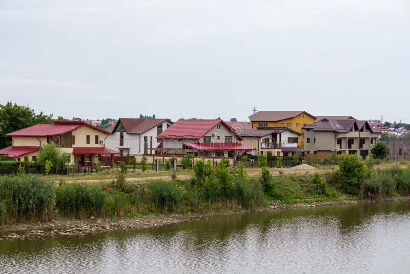 Complex of villas in full development on the edge of a lake in a gloomy day. Complex of villas in full development on the edge of a lake in a gloomy day