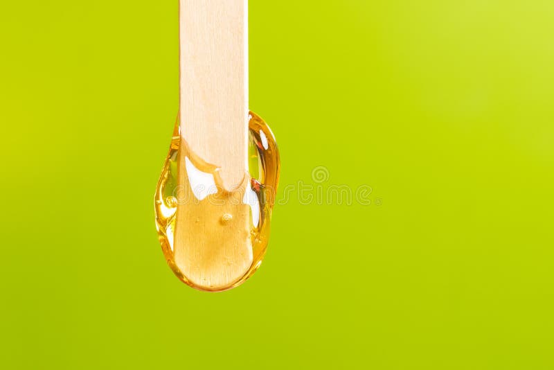 depilation and beauty concept - sugar paste or honey wax for hair removing spatula with wooden framing sticks on a bright green background, sugaring, body, care, cosmetic, female, gloves, hand, health, hygiene, jar, liquid, perfect, professional, removal, remove, salon, smooth, strip, waxing, woman, beautiful, bowl, clear, cosmetologist, cosmetology, depressor, foot, girl, home, leg, pain, procedure, skin, therapy, tongue, treatment, wellness, aromatherapy. depilation and beauty concept - sugar paste or honey wax for hair removing spatula with wooden framing sticks on a bright green background, sugaring, body, care, cosmetic, female, gloves, hand, health, hygiene, jar, liquid, perfect, professional, removal, remove, salon, smooth, strip, waxing, woman, beautiful, bowl, clear, cosmetologist, cosmetology, depressor, foot, girl, home, leg, pain, procedure, skin, therapy, tongue, treatment, wellness, aromatherapy