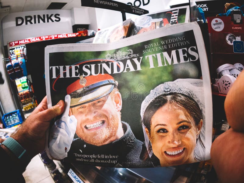 LONDON, ENGLAND - MAY 20, 2018: POV The Sunday Times front cover newspaper in British press kiosk featuring portraits of Prince Harry and Meghan Markle following the Royal Wedding lifestyle event. LONDON, ENGLAND - MAY 20, 2018: POV The Sunday Times front cover newspaper in British press kiosk featuring portraits of Prince Harry and Meghan Markle following the Royal Wedding lifestyle event