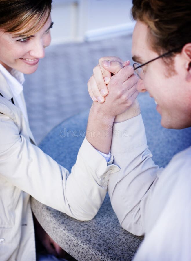 Business man and woman arm wrestling. Business man and woman arm wrestling