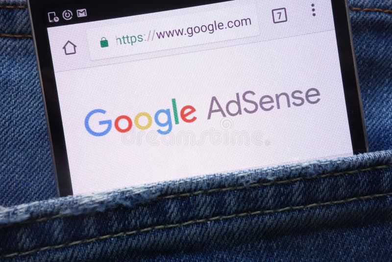 Google AdSense website displayed on smartphone hidden in jeans pocket