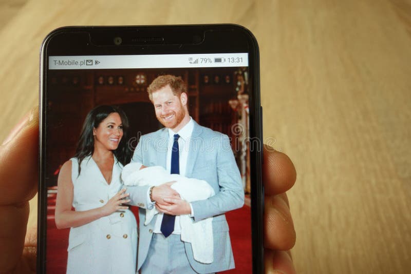 KONSKIE, POLAND - May 18, 2019: hand holding smartphone with photo of Prince Harry and Meghan Markle with baby displayed. KONSKIE, POLAND - May 18, 2019: hand holding smartphone with photo of Prince Harry and Meghan Markle with baby displayed