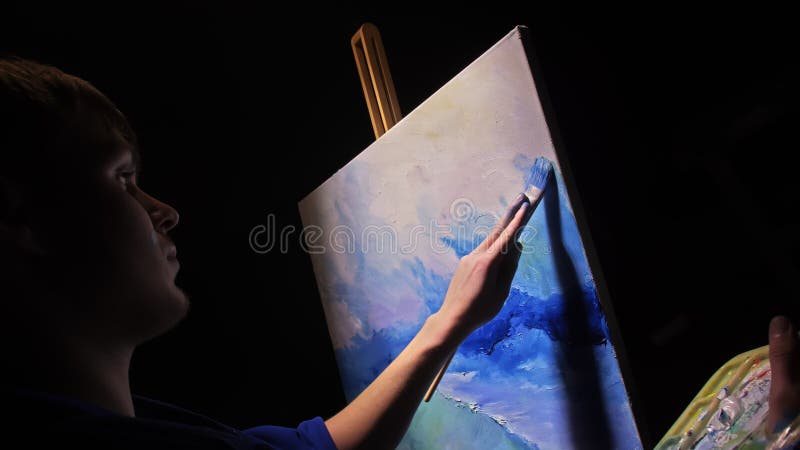 Artist copyist paint seascape with ship in ocean. Craftsman decorator draw as boat sail on blue sea with acrylic oil color. Draw finger, brush, knife palette. Indoor. Dark magic cinematic look. Artist copyist paint seascape with ship in ocean. Craftsman decorator draw as boat sail on blue sea with acrylic oil color. Draw finger, brush, knife palette. Indoor. Dark magic cinematic look.