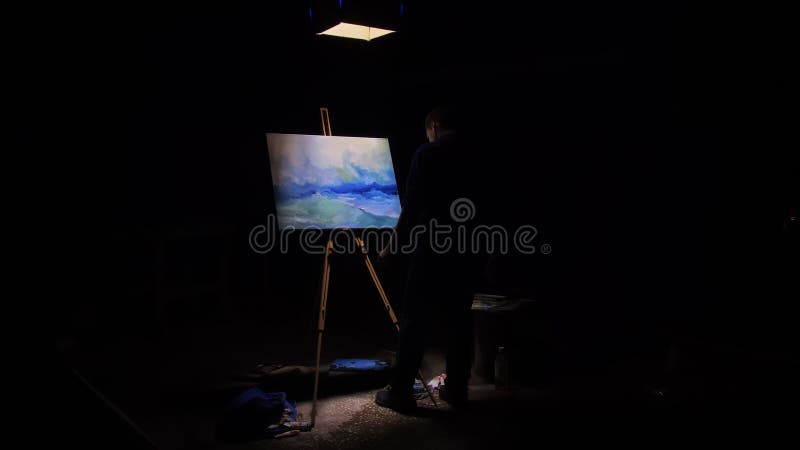 Artist copyist paint seascape with ship in ocean. Craftsman decorator draw as boat sail on blue sea with acrylic oil color. Black background. Indoor. Wide angle shot cinematic look. Artist copyist paint seascape with ship in ocean. Craftsman decorator draw as boat sail on blue sea with acrylic oil color. Black background. Indoor. Wide angle shot cinematic look.
