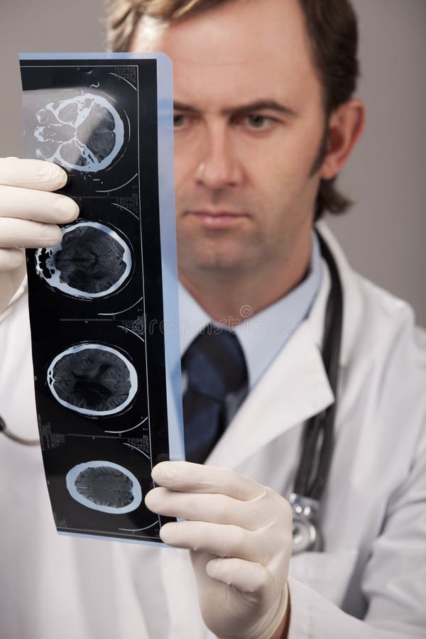 Doctor is checking x- ray computed tomography, studio shot. Doctor is checking x- ray computed tomography, studio shot.