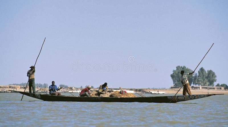 Konturer av folk på Niger River arkivbild Konturer av folk på Niger River arkivbild