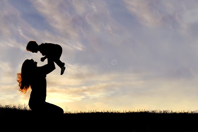 A silhouette of a happy young mother, laughing as she plays with her toddler child and lifts him over her head outside, isolated against the sunset. A silhouette of a happy young mother, laughing as she plays with her toddler child and lifts him over her head outside, isolated against the sunset.