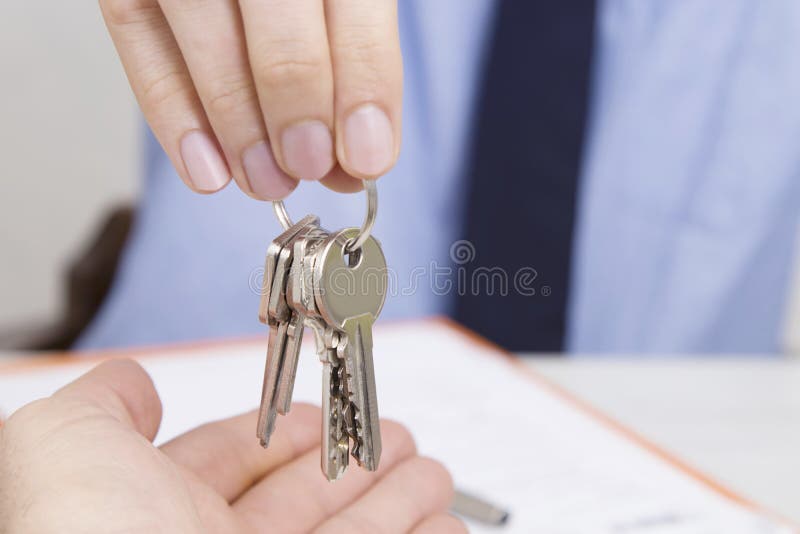 Hands with keys, concept of buying or renting house or apartment. Hands with keys, concept of buying or renting house or apartment